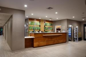 a lobby of a store with a counter and shelves at SpringHill Suites Savannah Airport in Savannah