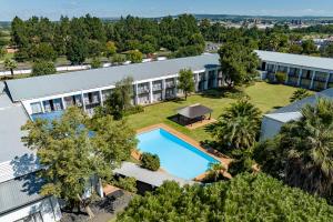 an aerial view of a building with a swimming pool at African Sky Newcastle Inn in Newcastle