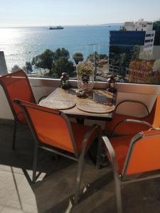 a table and chairs on a balcony with a view of the ocean at Amazing Sea Place in Limassol