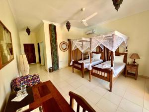Postel nebo postele na pokoji v ubytování Mahali Zanzibar