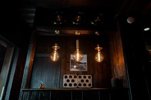 a room with three lights hanging from a wall at Hotel zum See, Titisee in Titisee-Neustadt