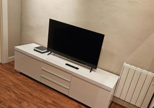a flat screen tv sitting on top of a white cabinet at APARTAMENTO CALLE CURIA 6 in Pamplona