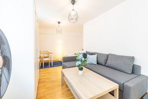 a living room with a couch and a table at CALM & EASY by JR City Apartments in Vienna +23 photos