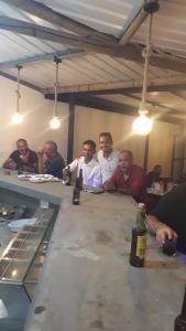 a group of men sitting around a long table at PREM VILLA in Petit Raffray
