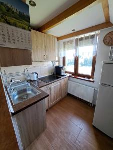 a small kitchen with a sink and a refrigerator at U Chowańców in Bańska Niżna