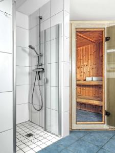 a shower with a glass door in a bathroom at Haus Maja in Kaltenhof