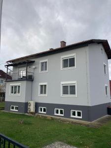 a white house with a balcony on the side of it at Wohnung in Haus in Neunkirchen