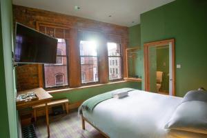 a bedroom with a bed and a large window at O'Regans in Dublin