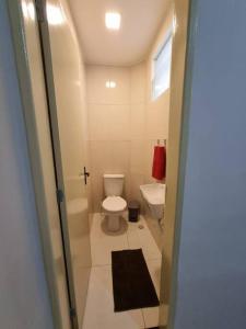 a small bathroom with a toilet and a sink at Casa 2/4 para temporada in Aracaju +16 photos