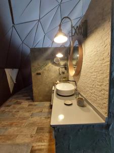 a bathroom with a sink and a mirror at Alaçatı Route 35 Glamping Konaklama&Restaurant in Germiyan