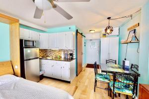 a bedroom with a bed and a kitchen with a table at Daytona Beach Club 708 in Daytona Beach