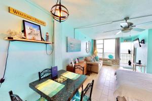 a living room with a table and a dining room at Daytona Beach Club 708 in Daytona Beach