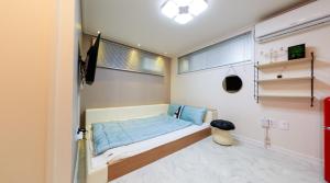um pequeno quarto com uma cama e uma janela em Real steel pension em Gyeongju