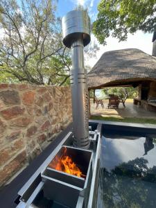 a fire pit next to a swimming pool at Wildevy at Benlize in Hartbeespoort