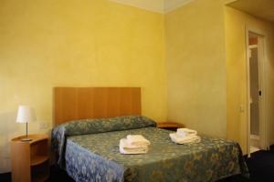 Postel nebo postele na pokoji v ubytování Club Hotel