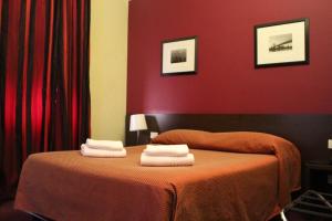 Postel nebo postele na pokoji v ubytování Club Hotel
