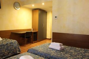 Postel nebo postele na pokoji v ubytování Club Hotel