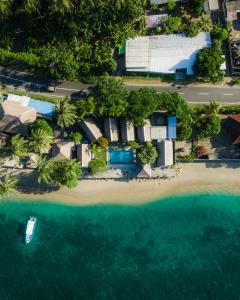 an aerial view of a resort with a boat in the water at Krisna Bungalows and Restaurant in Sekotong