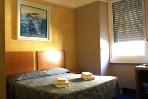 Postel nebo postele na pokoji v ubytování Club Hotel