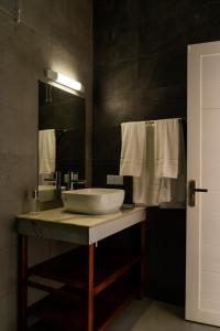 a bathroom with a sink and a mirror at Le Marin, Rodrigues Island in Rodrigues Island