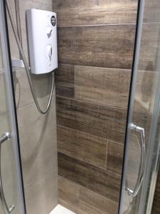 a shower in a bathroom with a glass door at Birch Tree House in Windermere