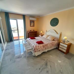 um quarto com uma cama com duas almofadas vermelhas em Villa Angie em Nerja
