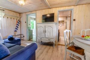 a living room with a blue couch and a table at Fajna Chatka (mieszkanko B) in Stegna