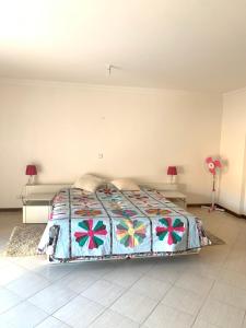 a bedroom with a bed with a quilt on it at Laginha Beachview in Mindelo