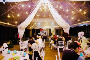 a group of people sitting at tables in a tent at THE PINE HOUSE in Kuala Berang +28 photos