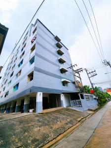 a building with balconies on the side of it at Homely Home Near BTS Kasetsart U. St. in Bangkok