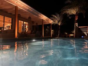 a swimming pool at night with a resort at Villa Nagabaaja in Saint Barthelemy