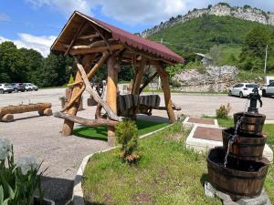 a playground with a wooden pavilion in a parking lot at Hotel Sole del Baldo in Brentonico