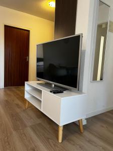 a flat screen tv sitting on top of a white entertainment center at Ferienwohnung Sunny in Bad Dürrheim