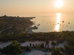a sunset over a body of water with boats at Governors Beach Panayiotis in Governors Beach