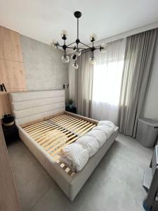 A bed or beds in a room at Luxury Apartments Słupsk
