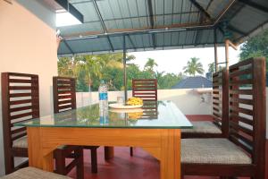a table with a plate of food and a bottle of water at BIJIS HOMESTAY in Alleppey