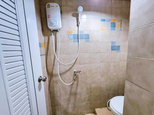 a shower in a bathroom with a toilet at Homely Home Near BTS Kasetsart U. St. in Bangkok
