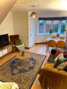 a living room with a couch and a table at Charming Home in Wellingborough in Wellingborough