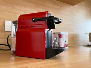 a red toaster sitting on top of a counter at Accogliente trilocale a Brescia in Brescia