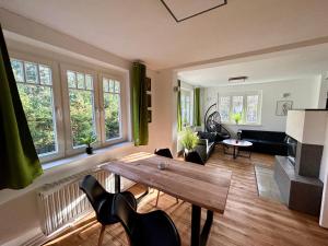 uma sala de estar com uma mesa de madeira e cadeiras em Ferienhaus im Grünen mit Kamin em Oranienburg