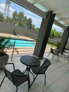 a patio with a table and chairs and a pool at nile apartment with power backup in Sandton