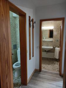 a bathroom with a toilet and a sink at Der Engel in Winterberg +18 photos
