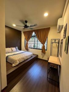 a bedroom with a bed and a ceiling fan at Villa Max Klebang 25 Pax 6R4B in Melaka