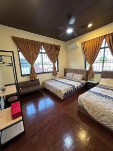 a bedroom with two beds and two windows at Villa Max Klebang 25 Pax 6R4B in Melaka