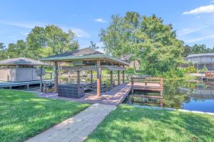 a gazebo with a picnic table in a park at Best of Both Worlds Lakehouse in Orlando