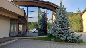 a building with a christmas tree in front of it at Penzión Villa in Rajecké Teplice