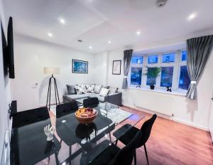 a living room with a glass table and chairs at Central London Apartment Camden in London