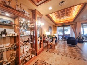 a large room with a table and chairs and a room with a store at Hotel Florida Lerici in Lerici