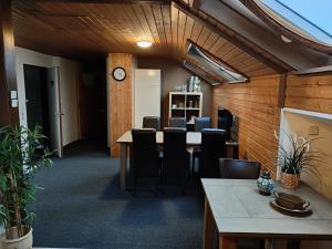 a conference room with a table and chairs and a clock at Der Engel in Winterberg