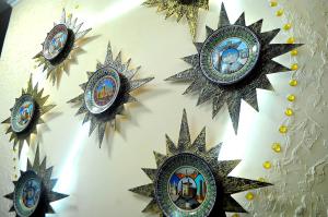 a group of clocks hanging on a wall at 7 Pir in Bukhara +89 photos